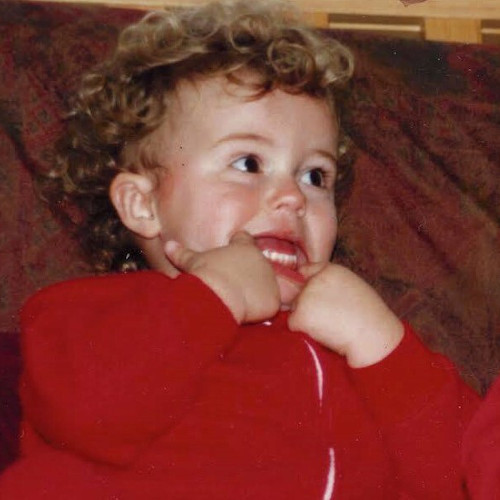 Alex as a small child pulling his low lip down into a funny face.